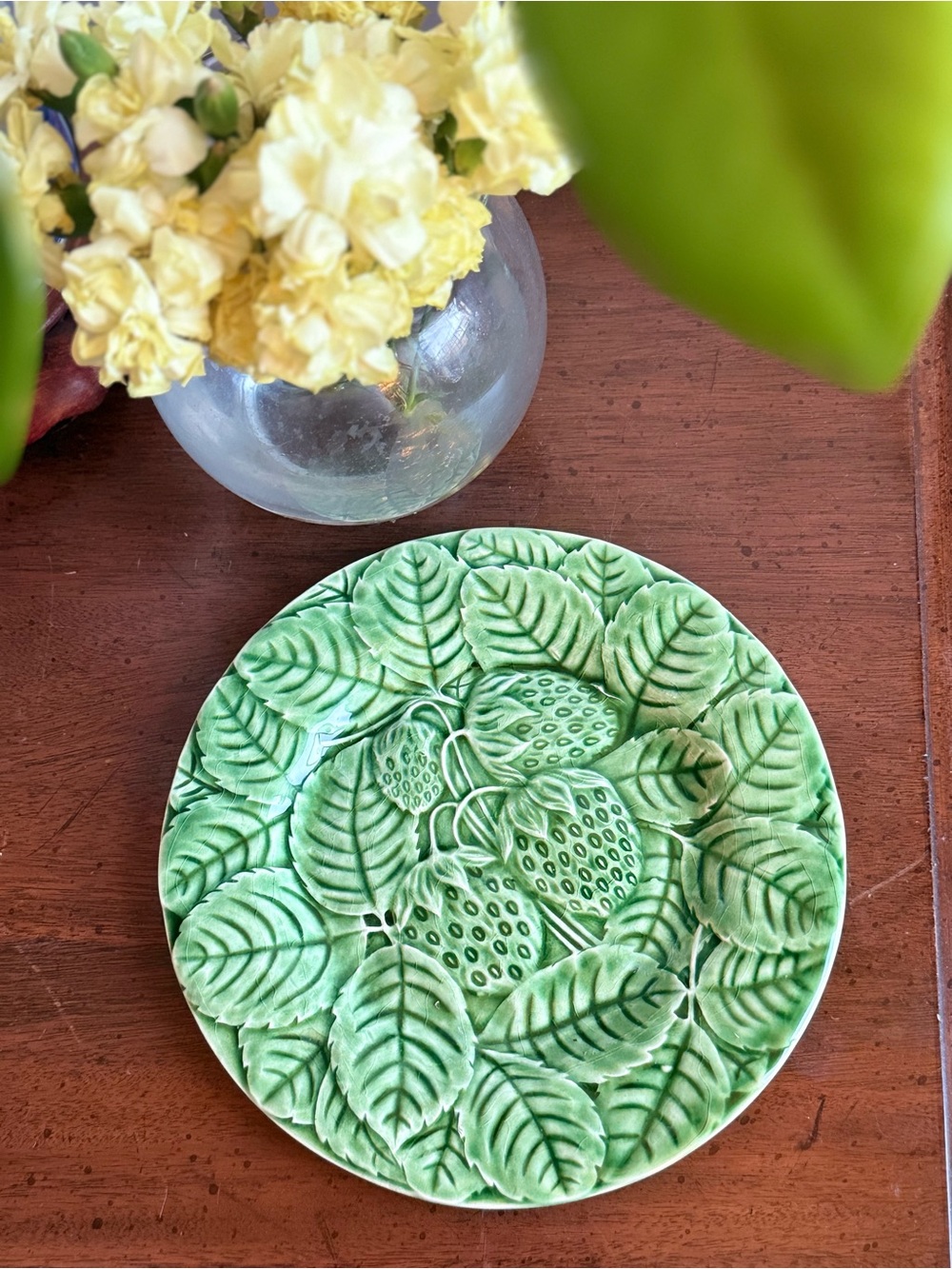 Bordallo Pinheiro plate with raised strawberry and leaf motifs.